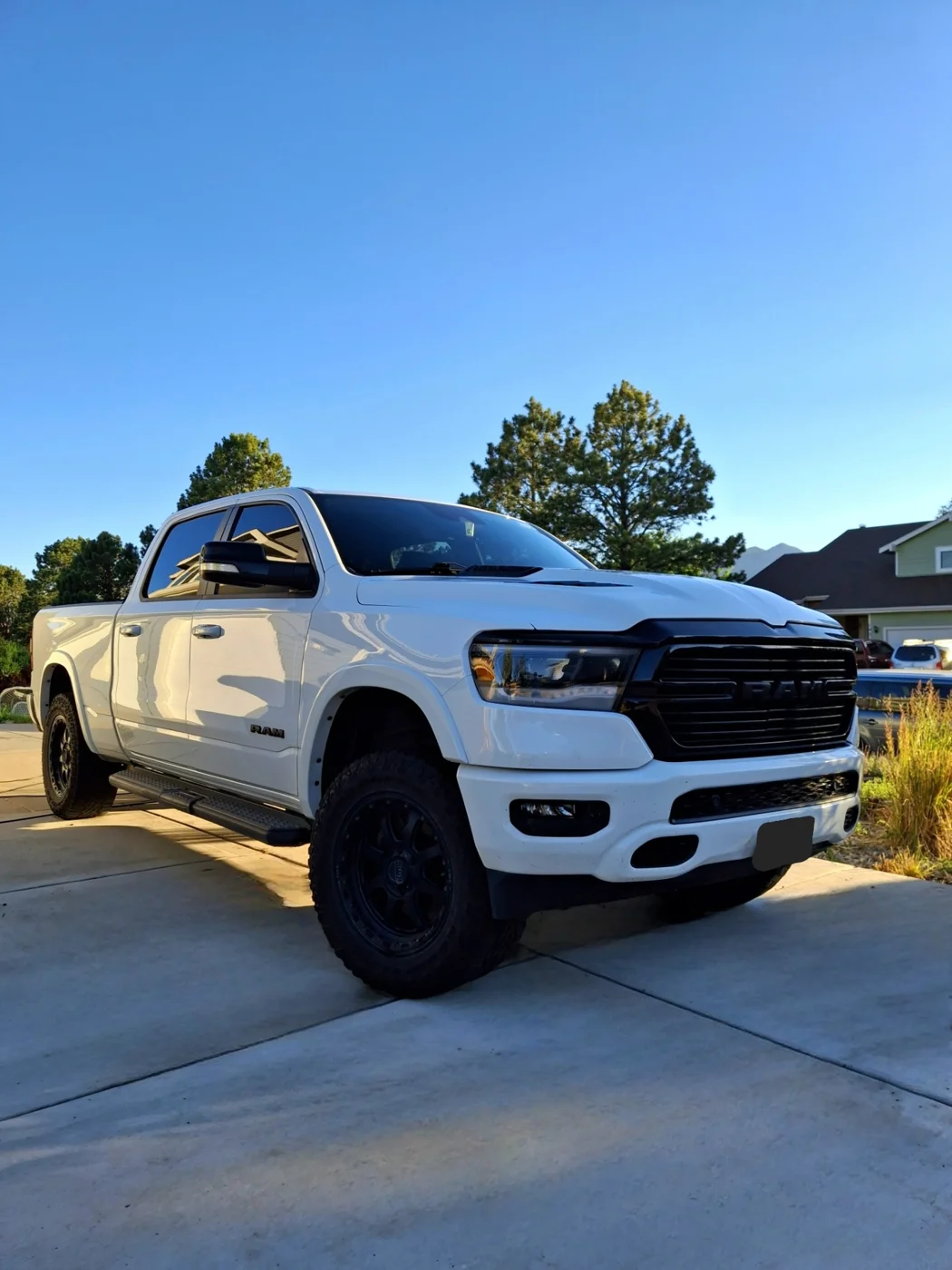 White Ram pickup shining in a driveway