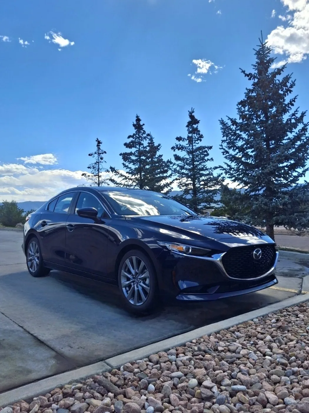 Dark blue Mazda sedan with a glossy detailed finish