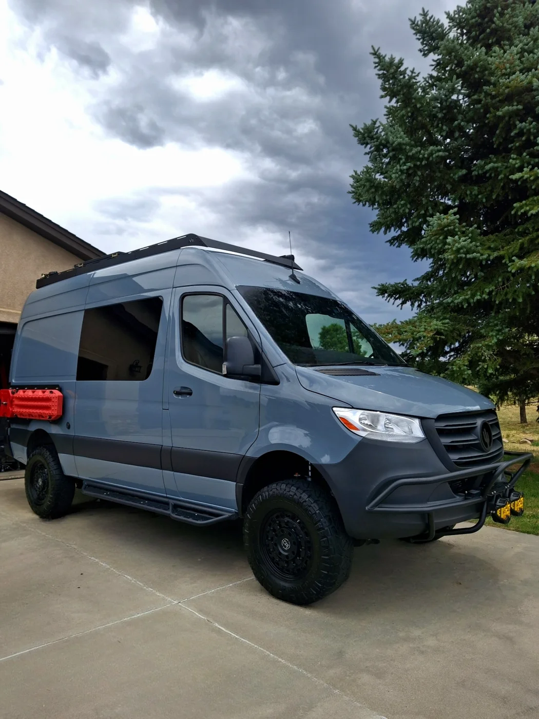 Gray camper van parked in a driveway