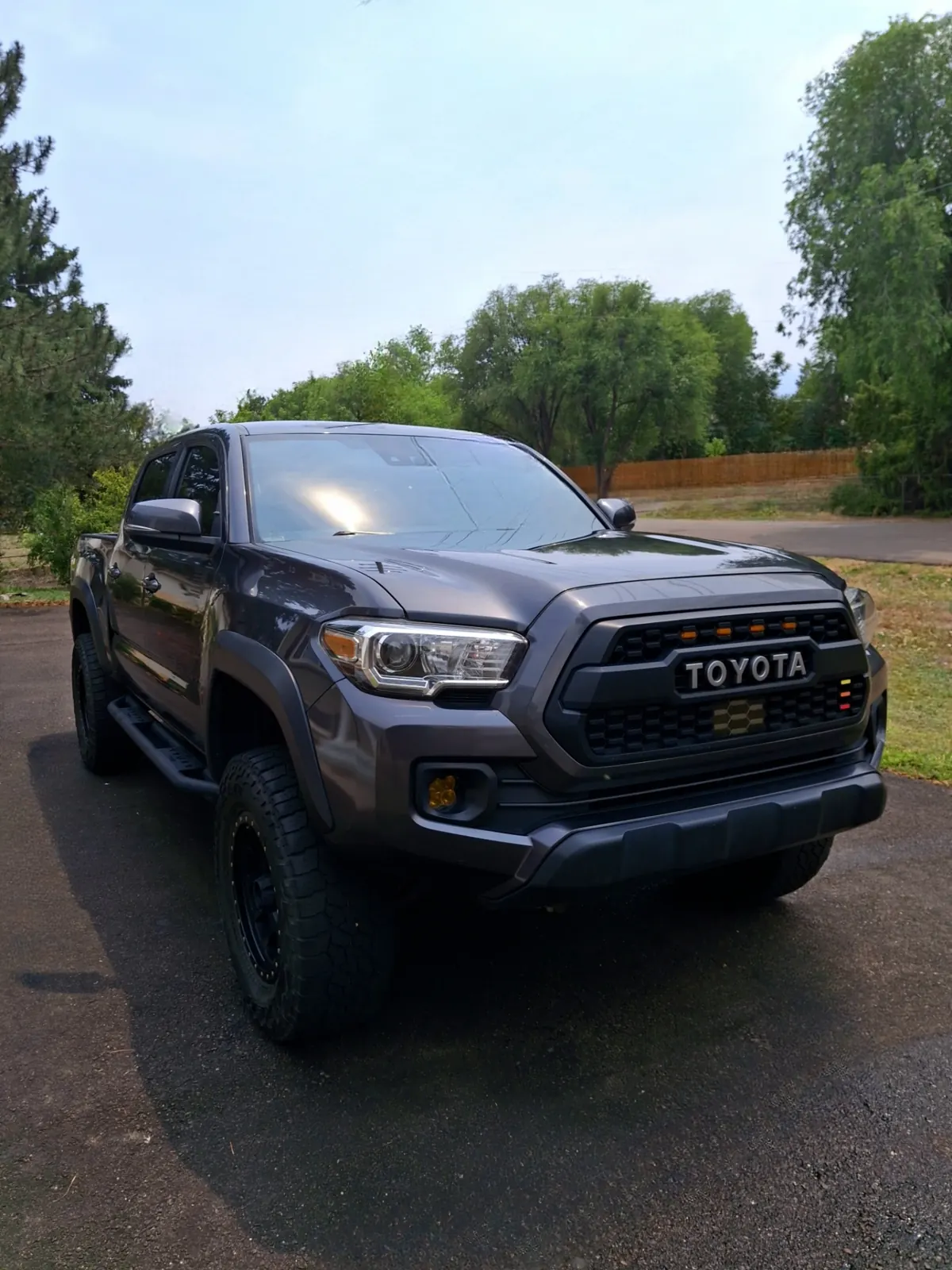 Dark gray Toyota Tacoma parked on a driveway after a mobile exterior detail in Colorado Springs
